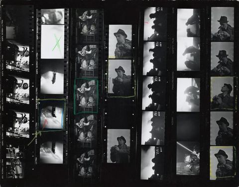 Photographic contact sheet. Seven strips of black and white film show firefighters working and the photographer, camera poised. Five images are outlined in yellow or green, and one has a red check mark.